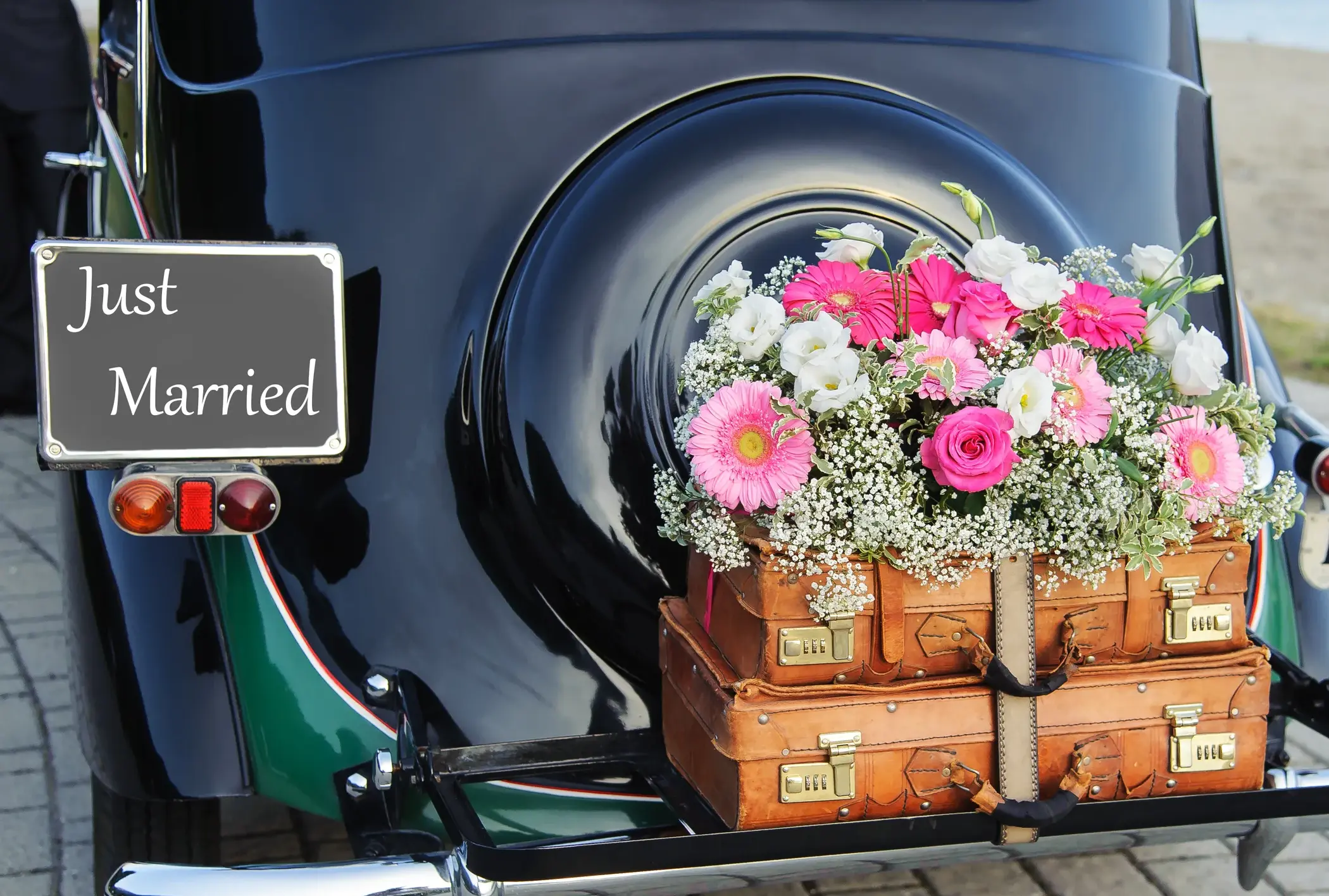 Tale end of a car with bridal bouquet