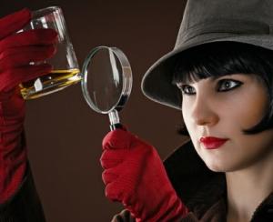 Detective looking at a glass using a magnifying glass
